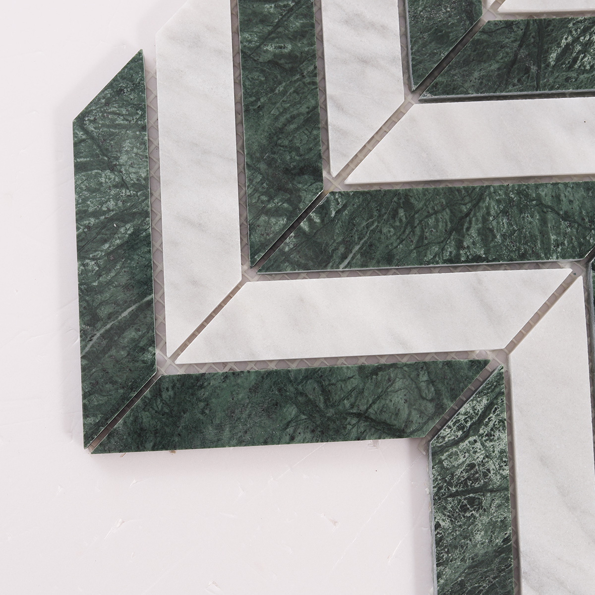 Close-up of Green & White Herringbone Honed marble mosaic tiles