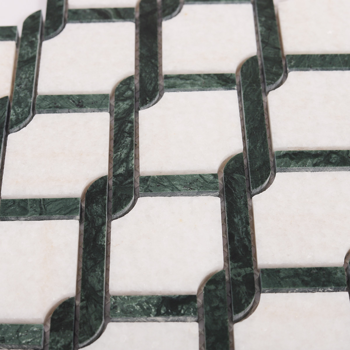 Close-up view of Thassos Green and White Princess Weave natural stone mosaic tiles.