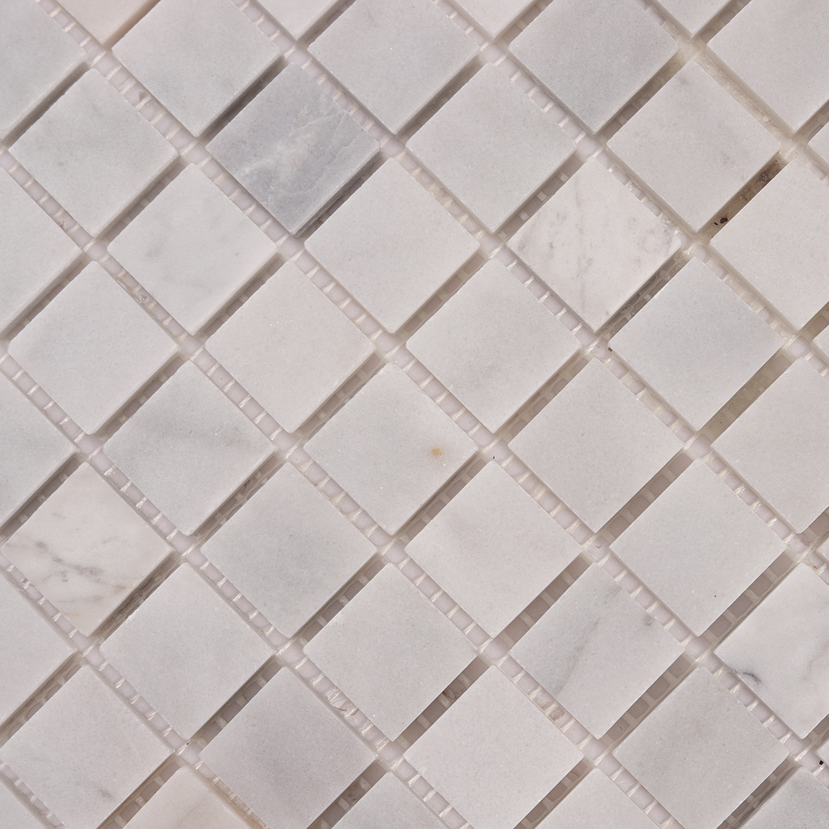 Close-up of Carrara Venato Square Honed Marble Mosaic Tiles.