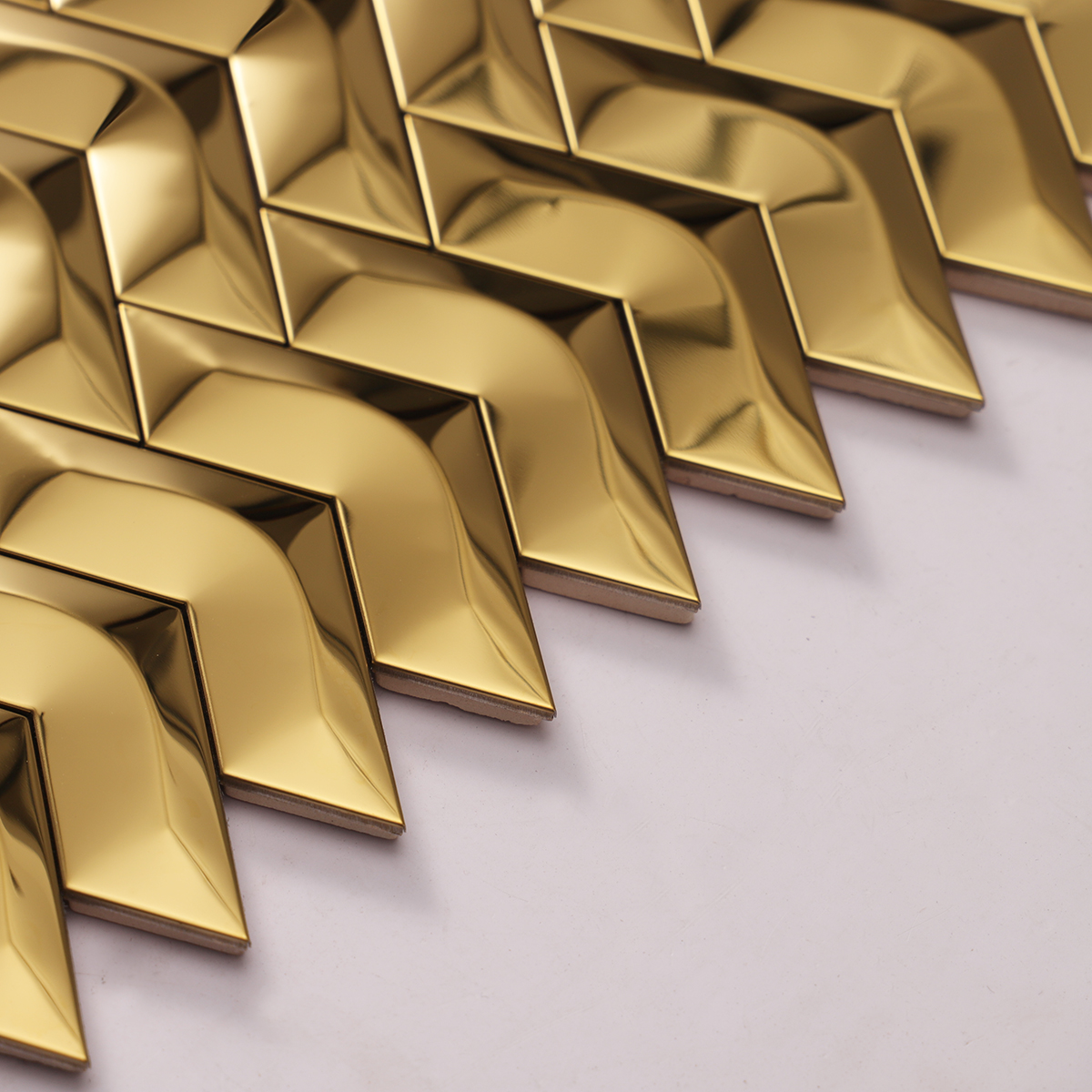 Side view close-up of 3D Gold Herringbone Mirror Stainless Steel Mosaic Tile, edge detail,