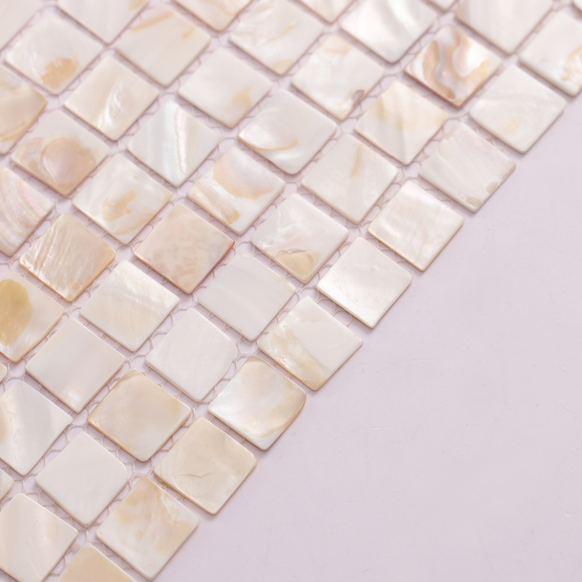 Side view close-up of Seashell Mother of Pearl Square Mosaic Tiles, showing thickness