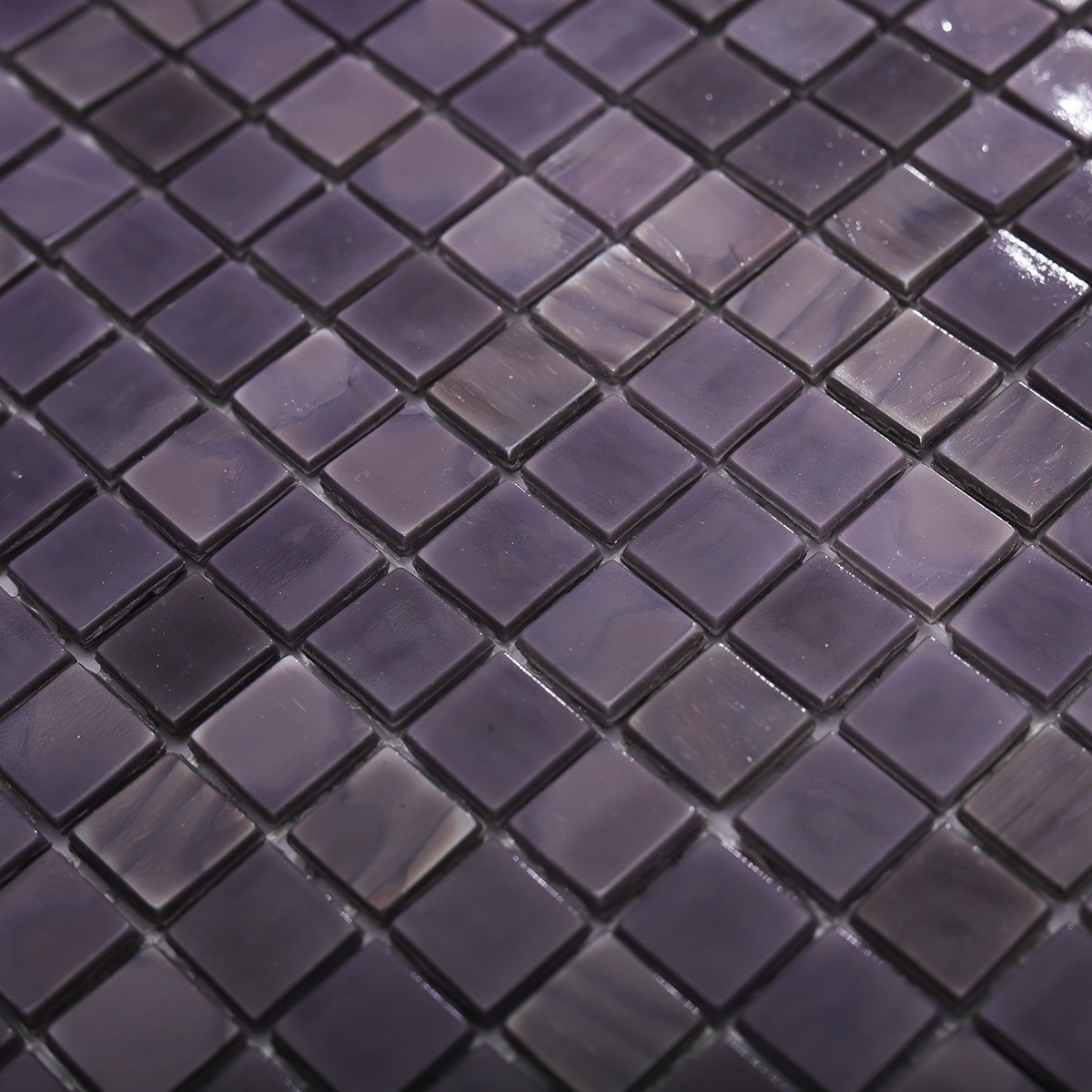 Close-up of the smooth surface and shine of the dark purple glass mosaic tile