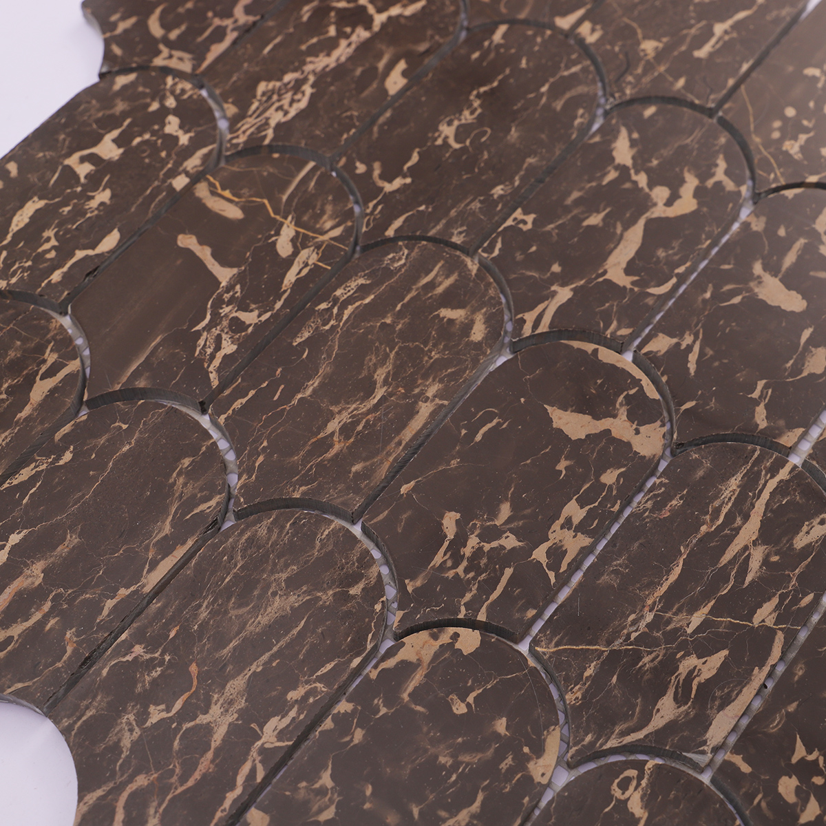 Detailed view of dark marble mosaic tile, highlighting gold veins and smooth surface