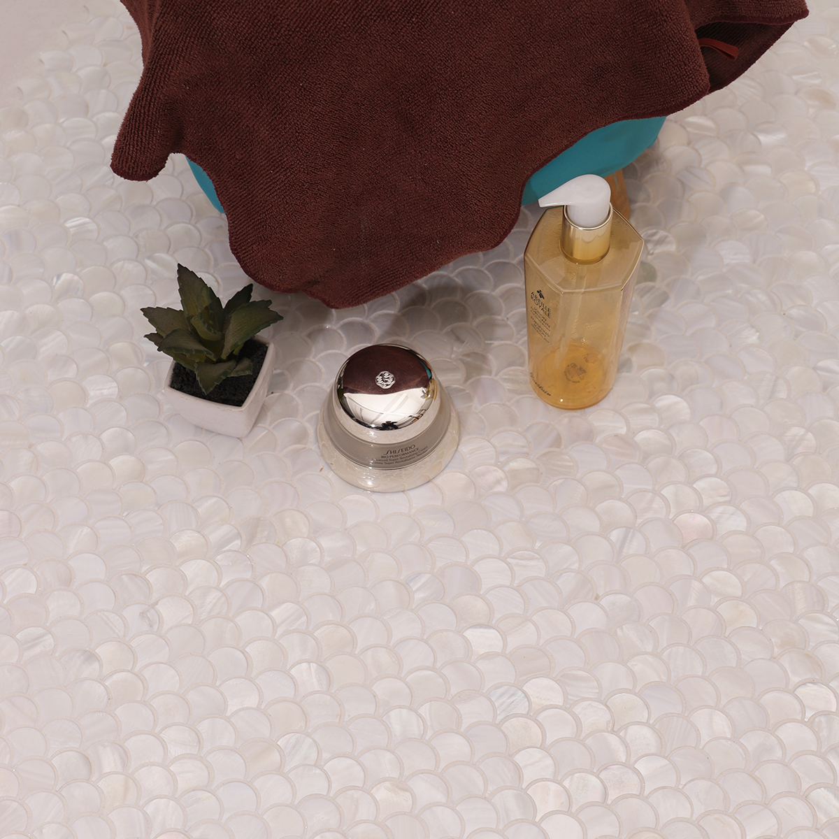 White fish scale mother of pearl mosaic tiles arranged in an elegant pattern. 