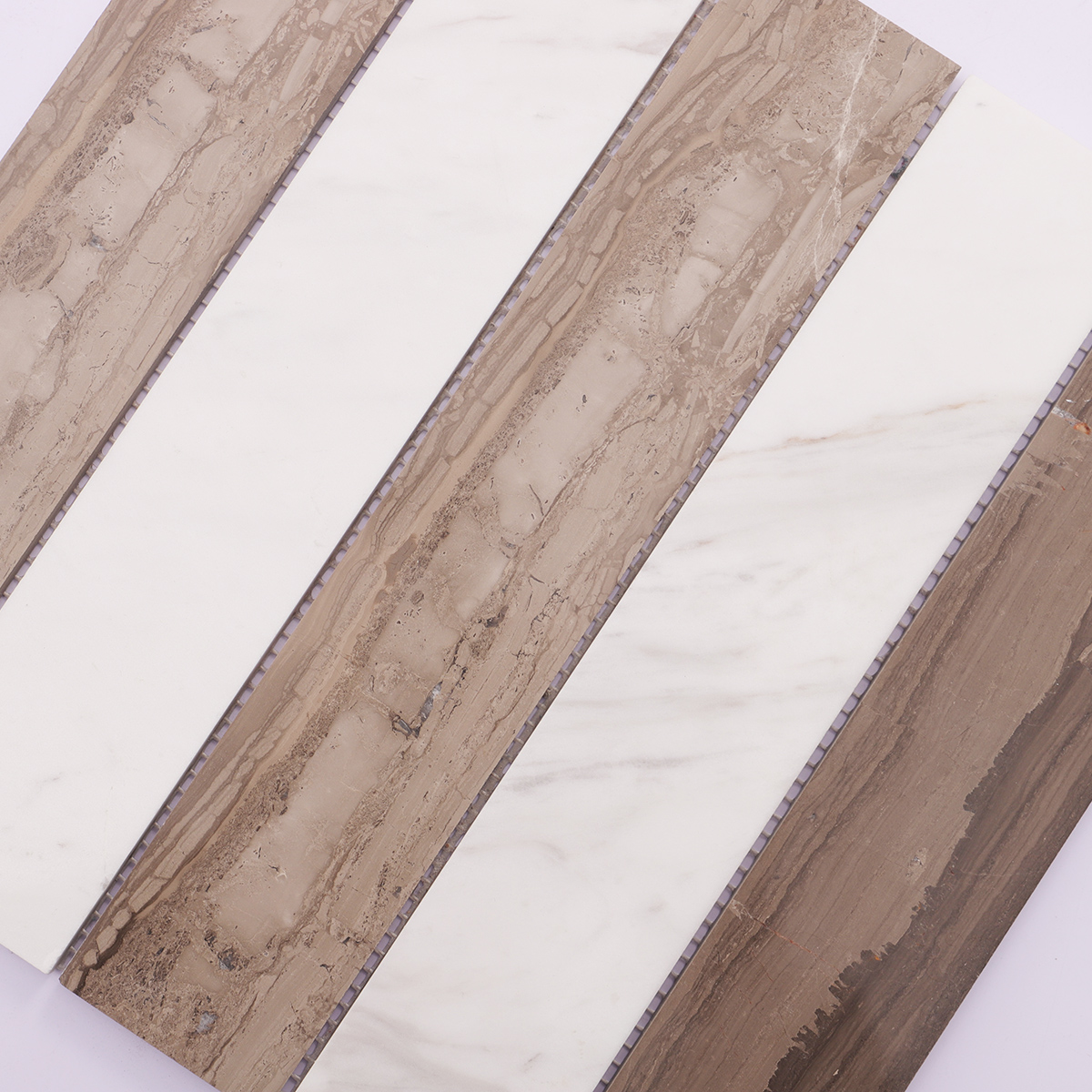 Close-up showing the intricate texture and design of beige marble mosaic tiles