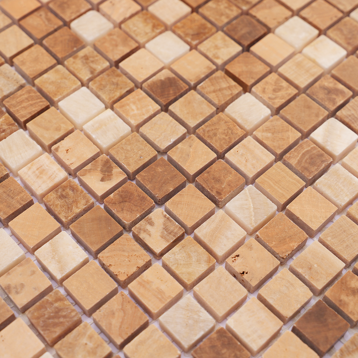 Detailed view highlighting the wood-like grain of light brown marble mosaic tiles.