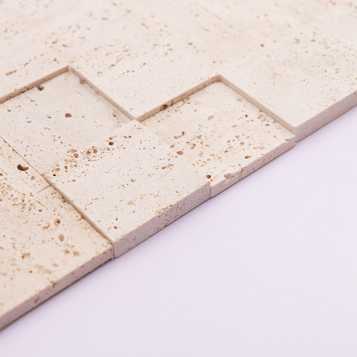 Side view showing the thickness of beige square 3D travertine mosaic tiles.