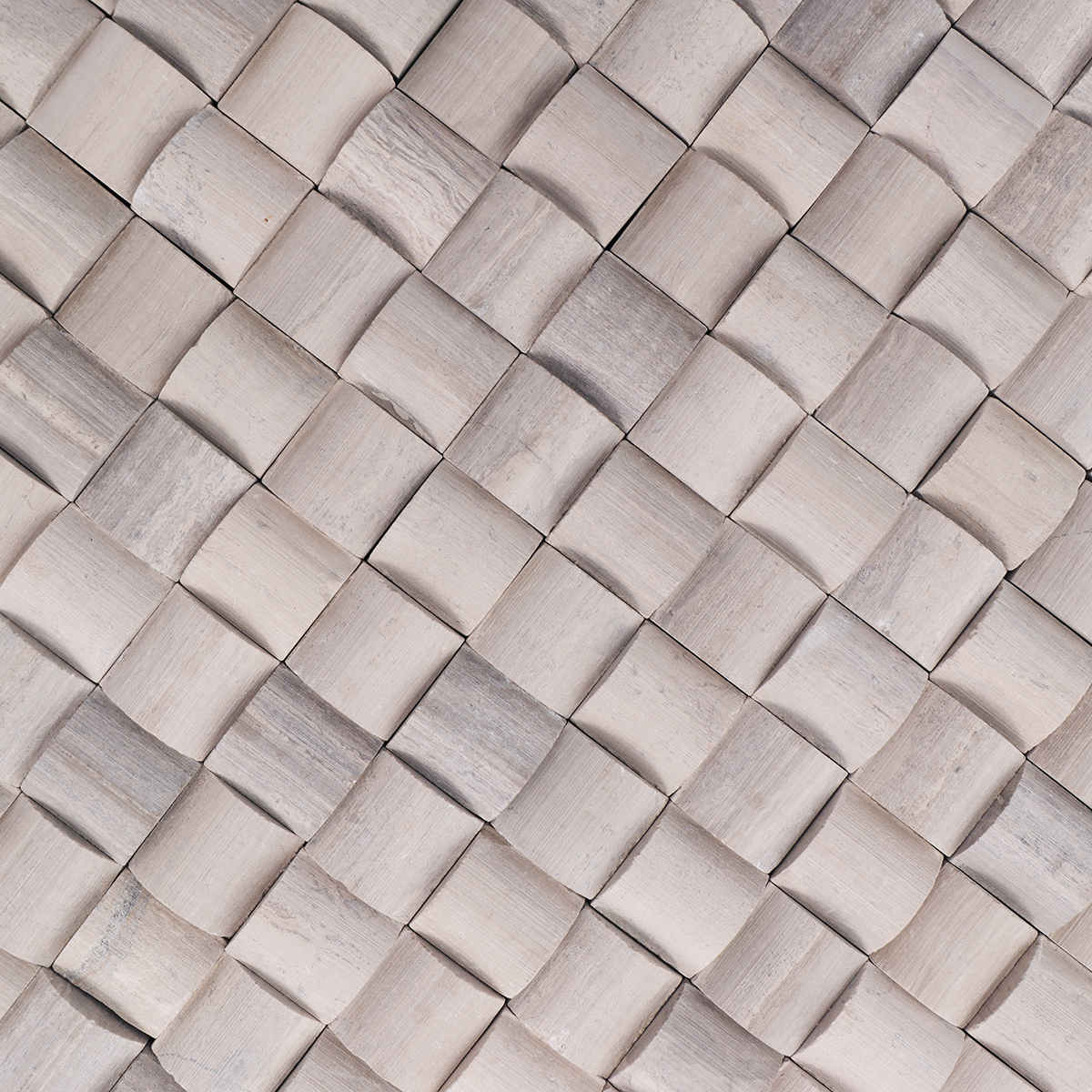 Detailed view highlighting the texture and curvature of the 3D gray marble mosaic tiles.