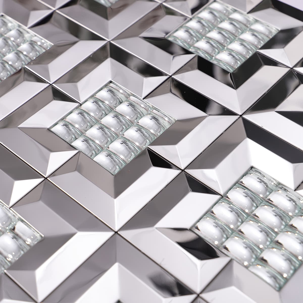 Angled detail of silver glass and metal mosaic tile surface