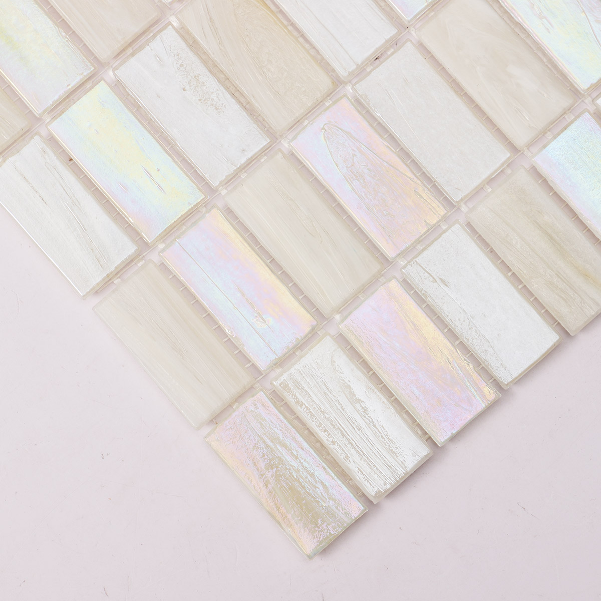 Close-up view of rectangle beige multicolor iridescent glass mosaic tiles.