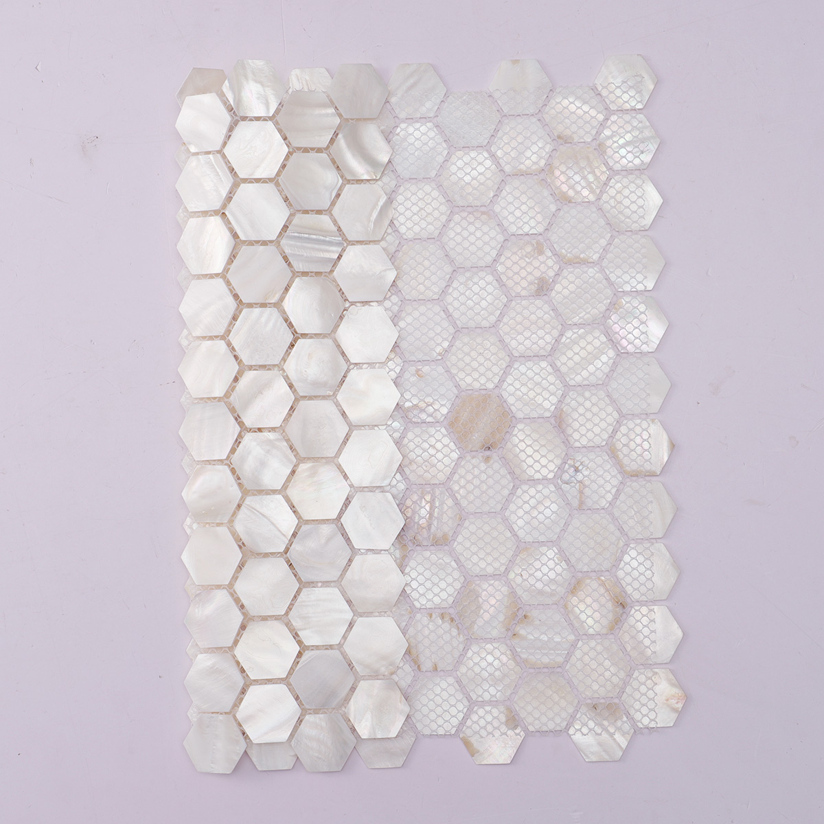 White hexagon mother of pearl mosaic tiles with folded backing.