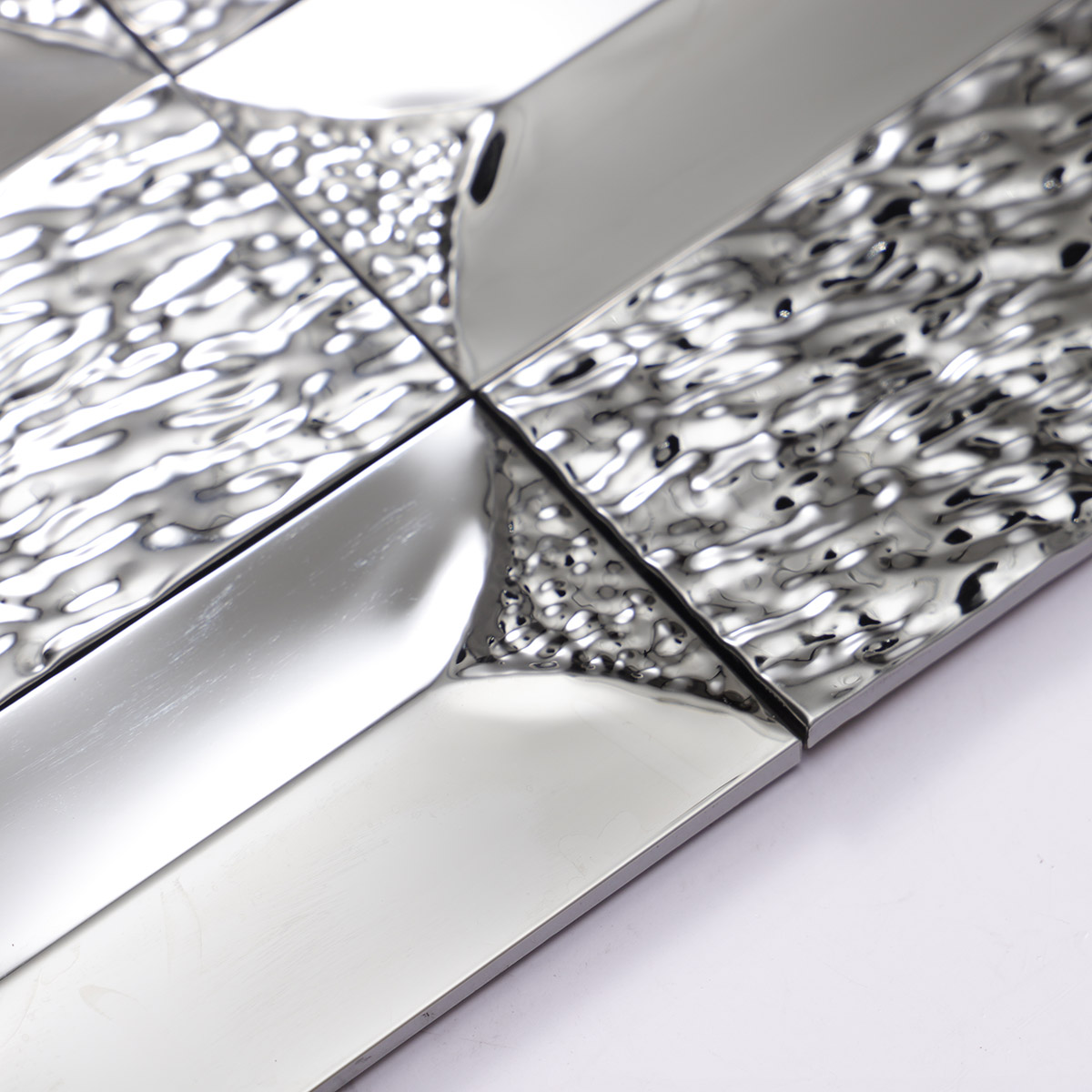 Close-up of the side of 3D stainless silver rectangle mosaic tiles