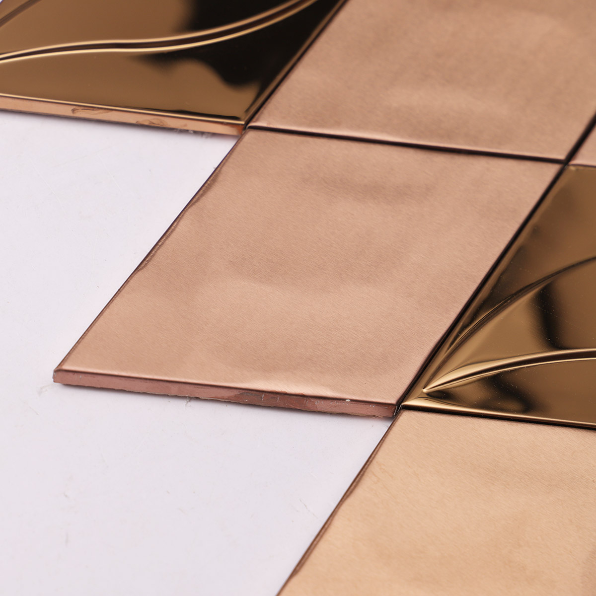 Close-up of the side of rose gold diamond metal mosaic tiles