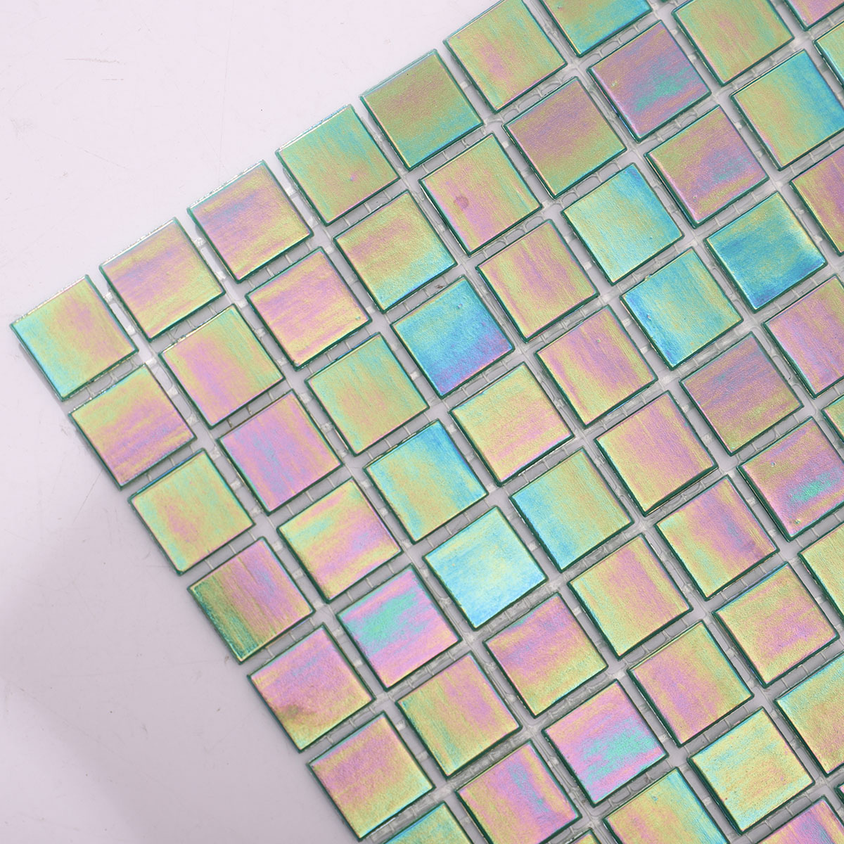 Side close-up of glossy iridescent emerald green square mosaic tiles