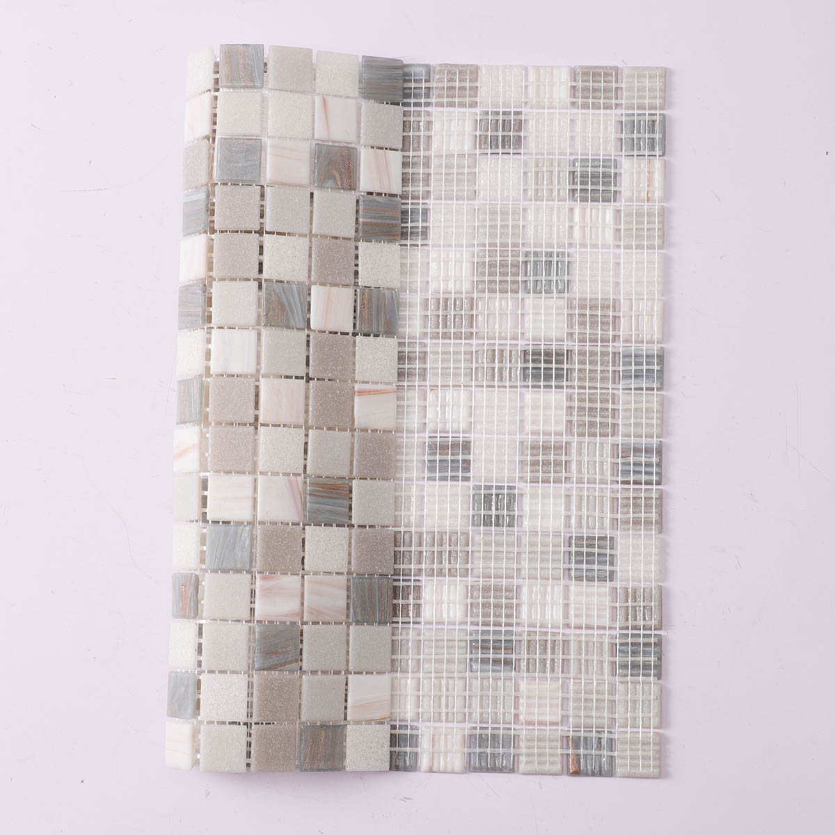 Folded back side of gray and white glass mosaic tiles