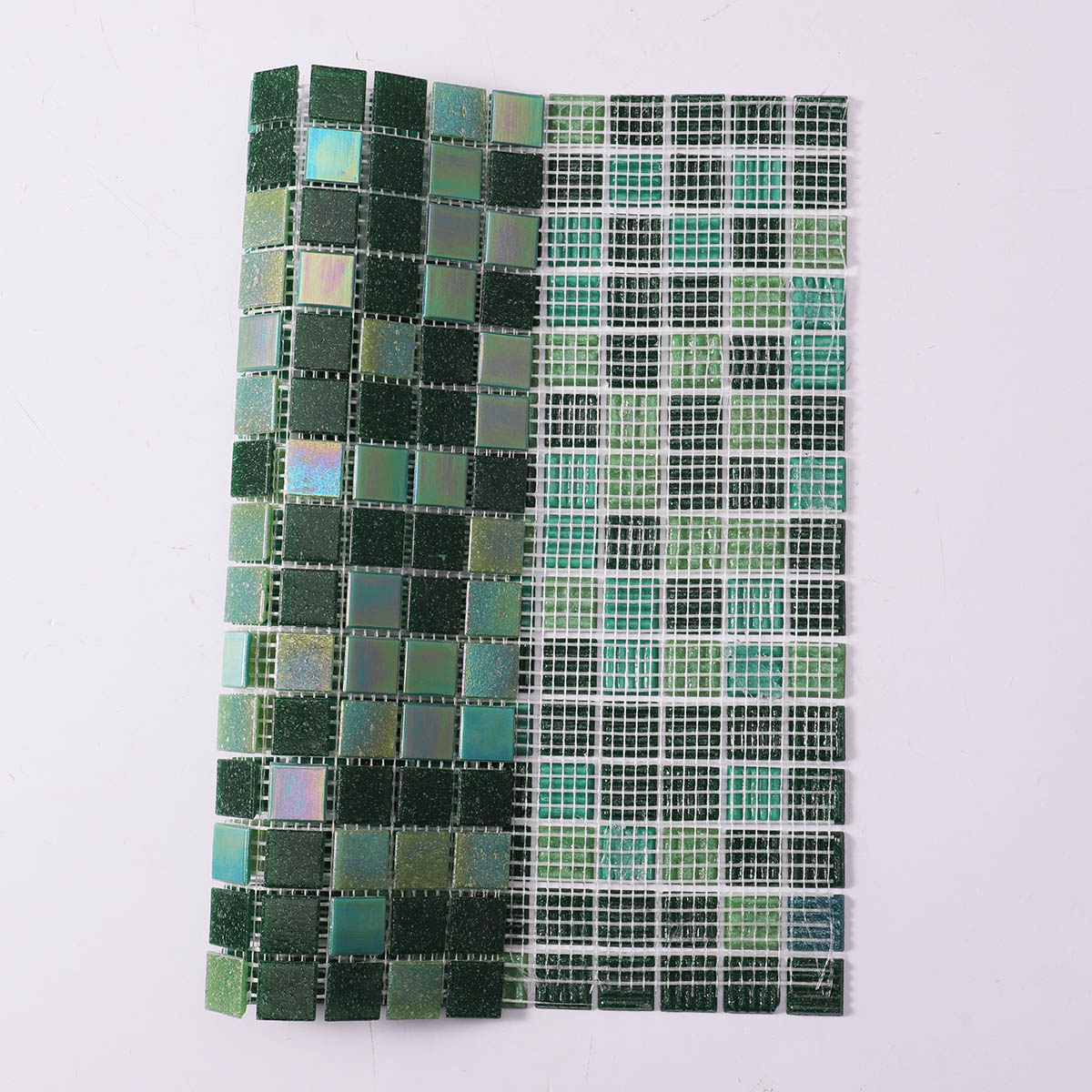 Back side of iridescent green square glass mosaic tiles, folded