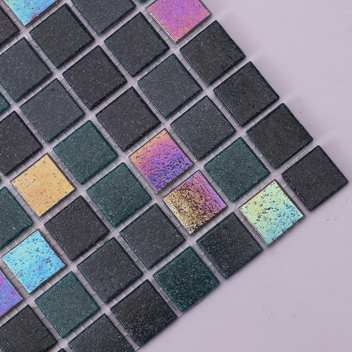 Close-up side view of black mix bottle green glass mosaic tile