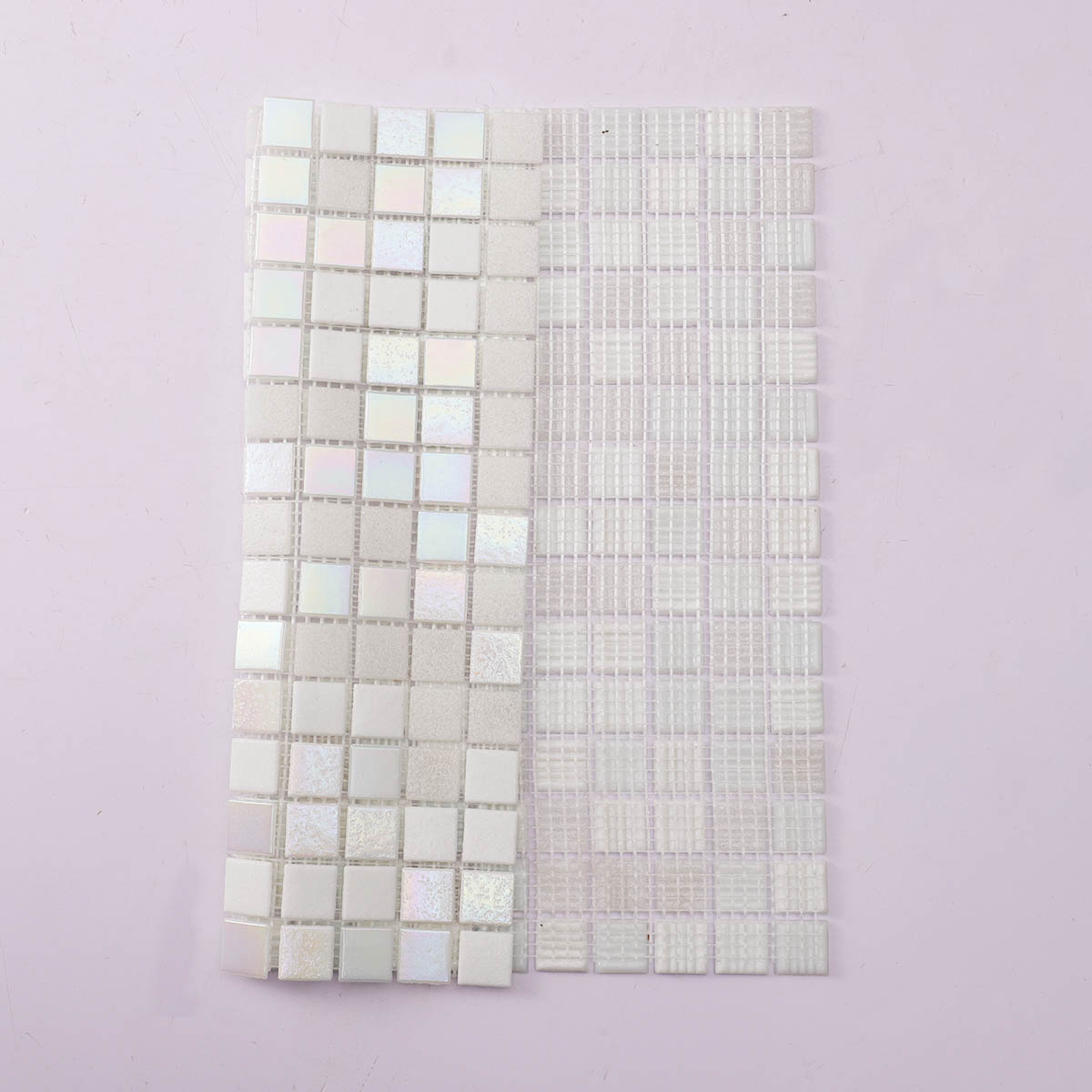 Mesh mounted back side of shining white square glass mosaic tiles, folded