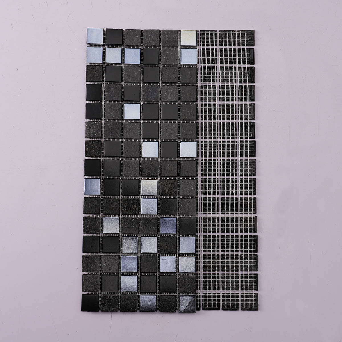 Back side of black square glass mosaic tiles, folded