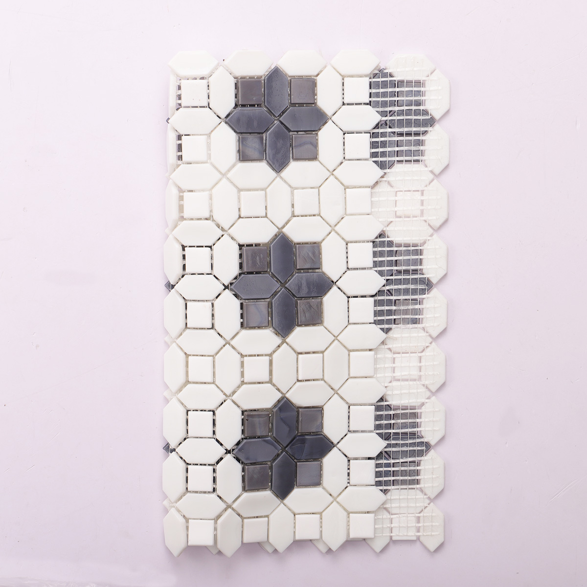 Folded view of back side of gray and white glass picket mosaic tiles