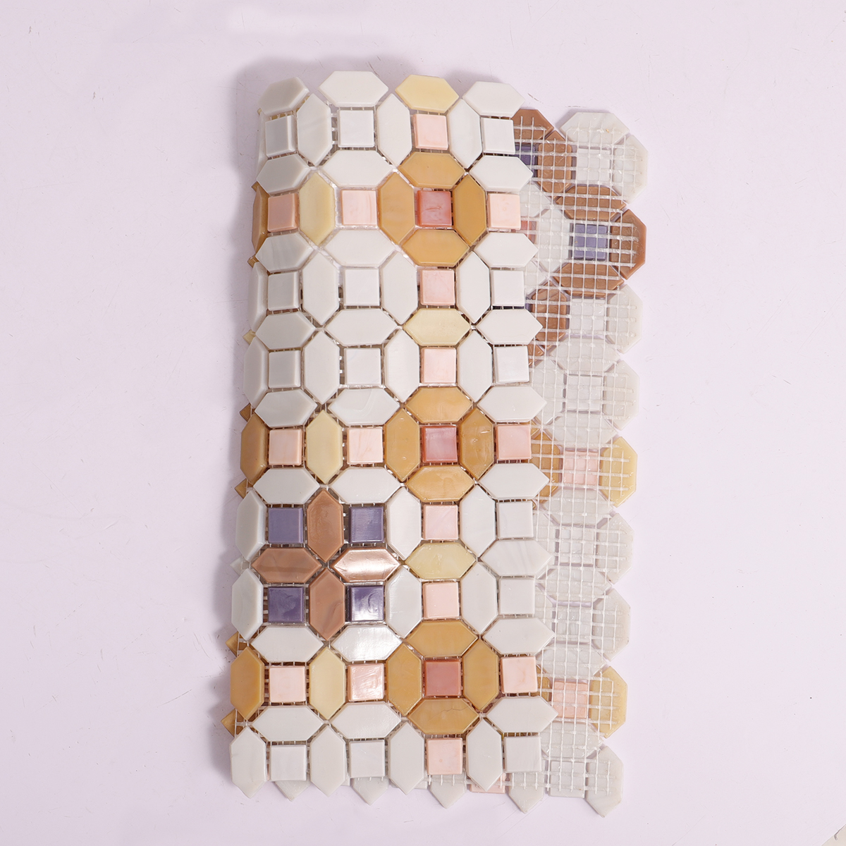Folded back side of floral orange and white glass mosaic tiles