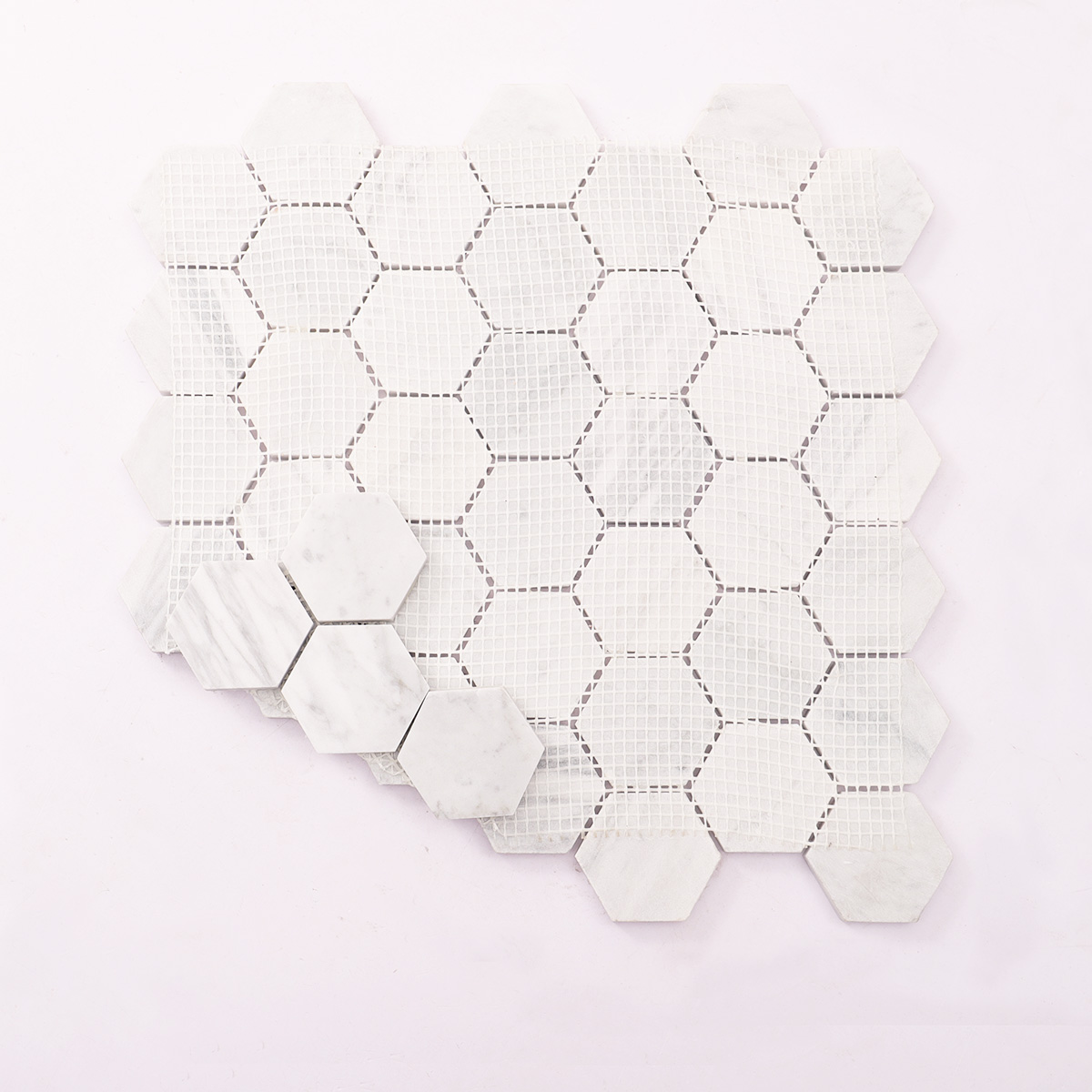 Folded back side of Carrara white hexagon marble mosaic tiles.