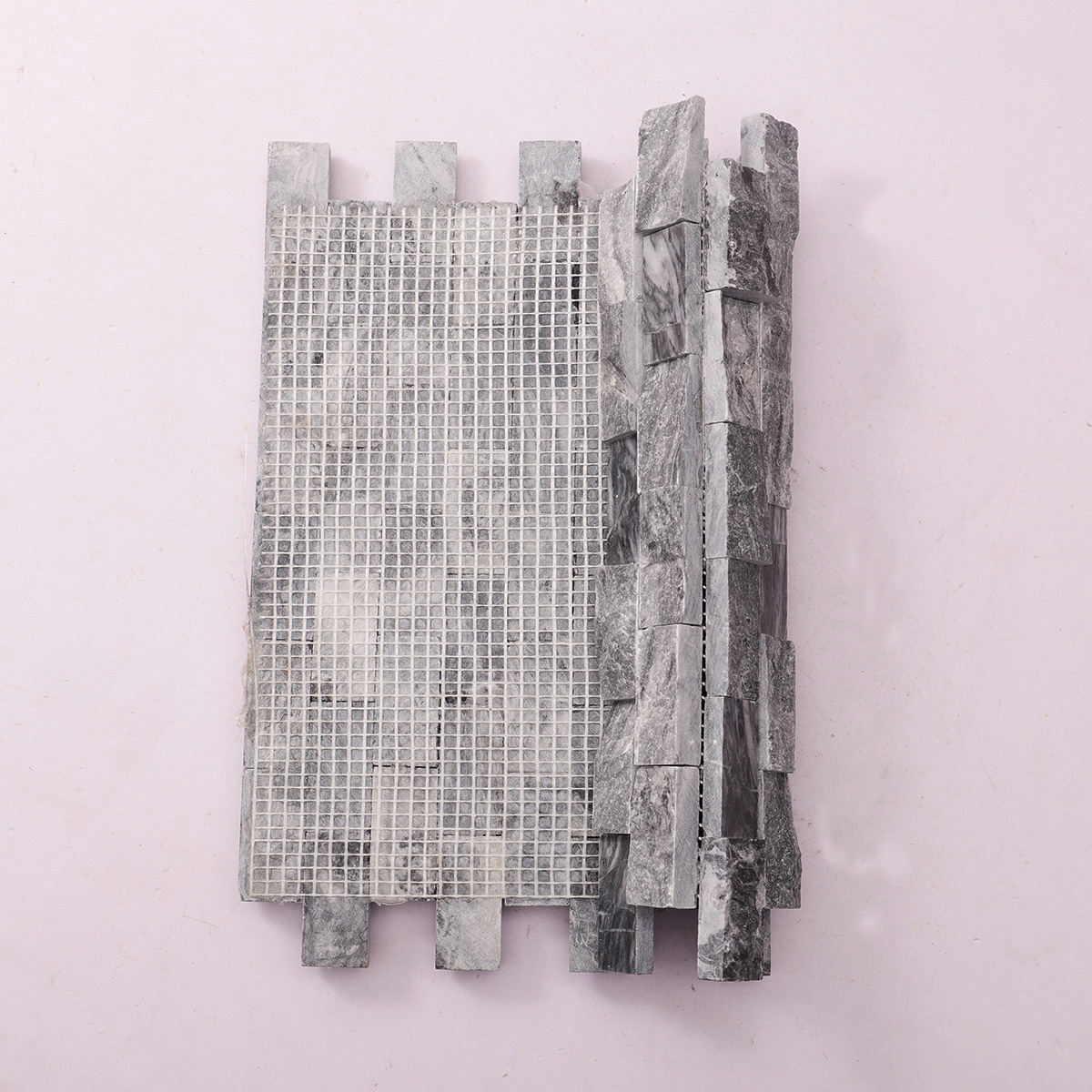 Folded back side of gray split face marble mosaic wall tiles.