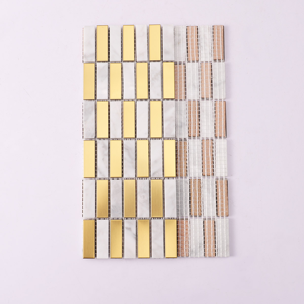 Folded back side of gold metal and Carrara white marble mosaic tiles.