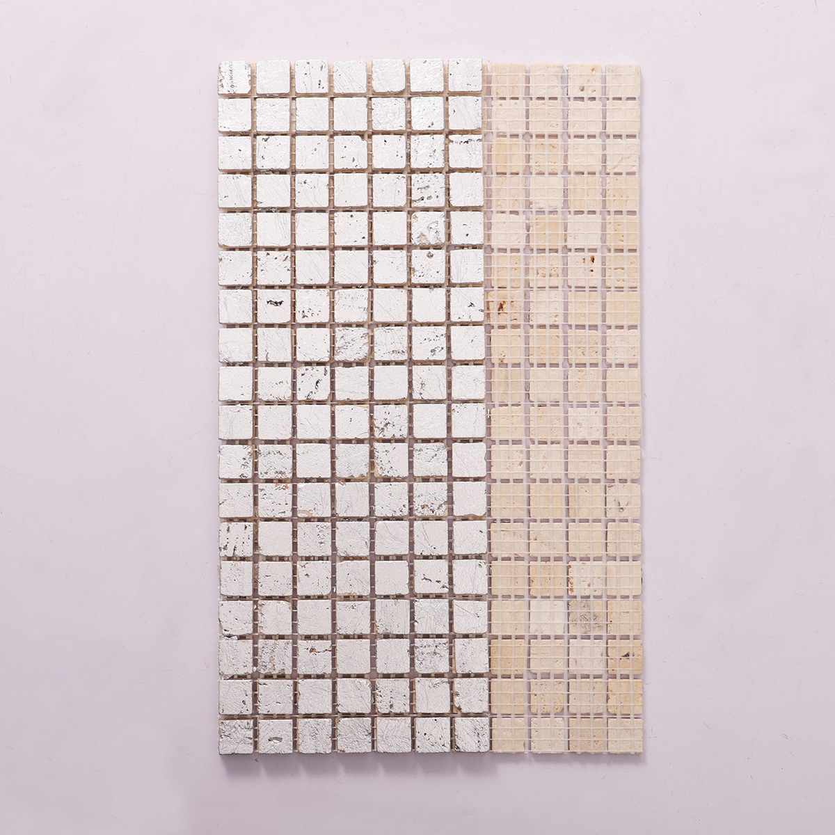 Back side of silver foil travertine mosaic wall tiles, folded.