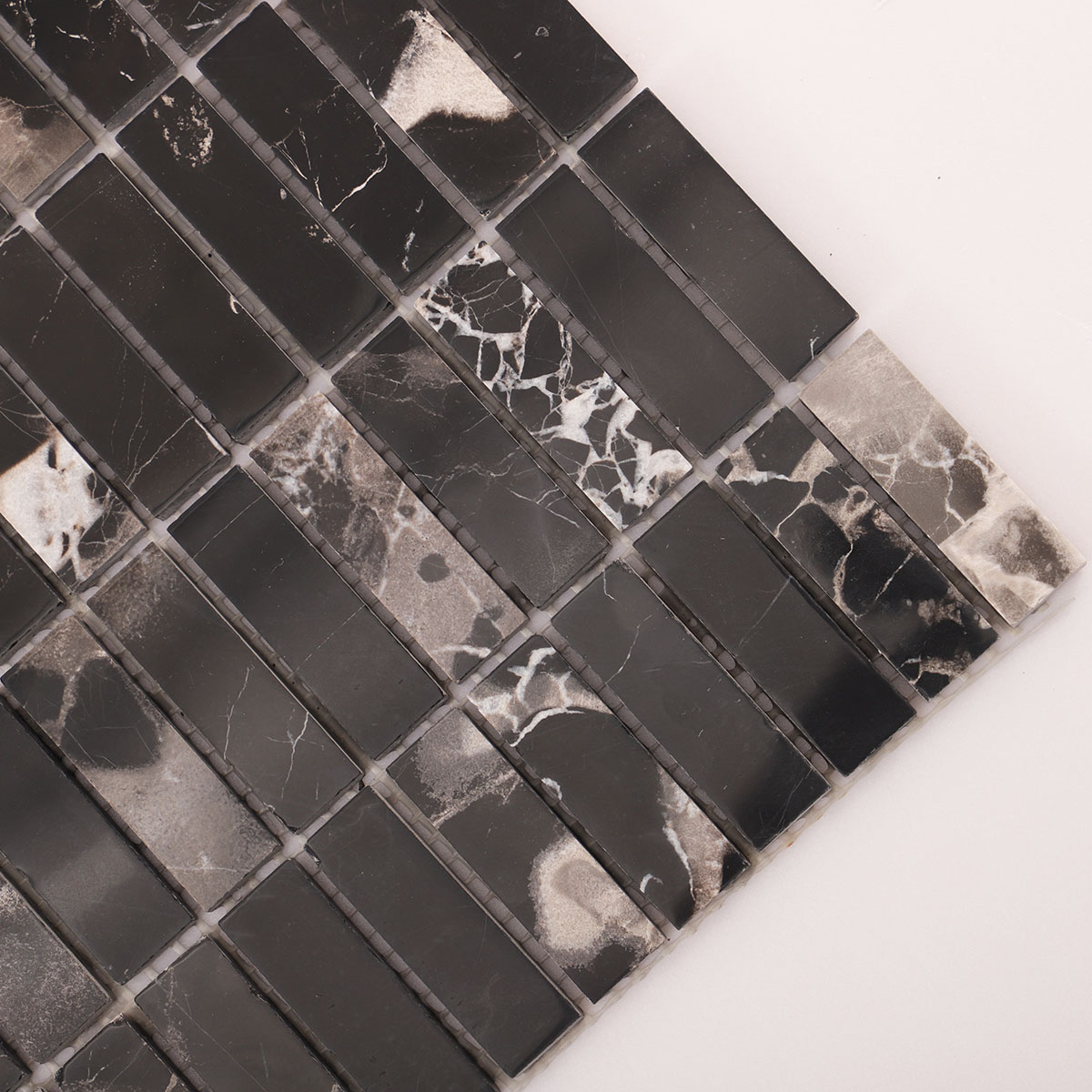 Detailed close-up of Nero Marquina black polished marble mosaic tile