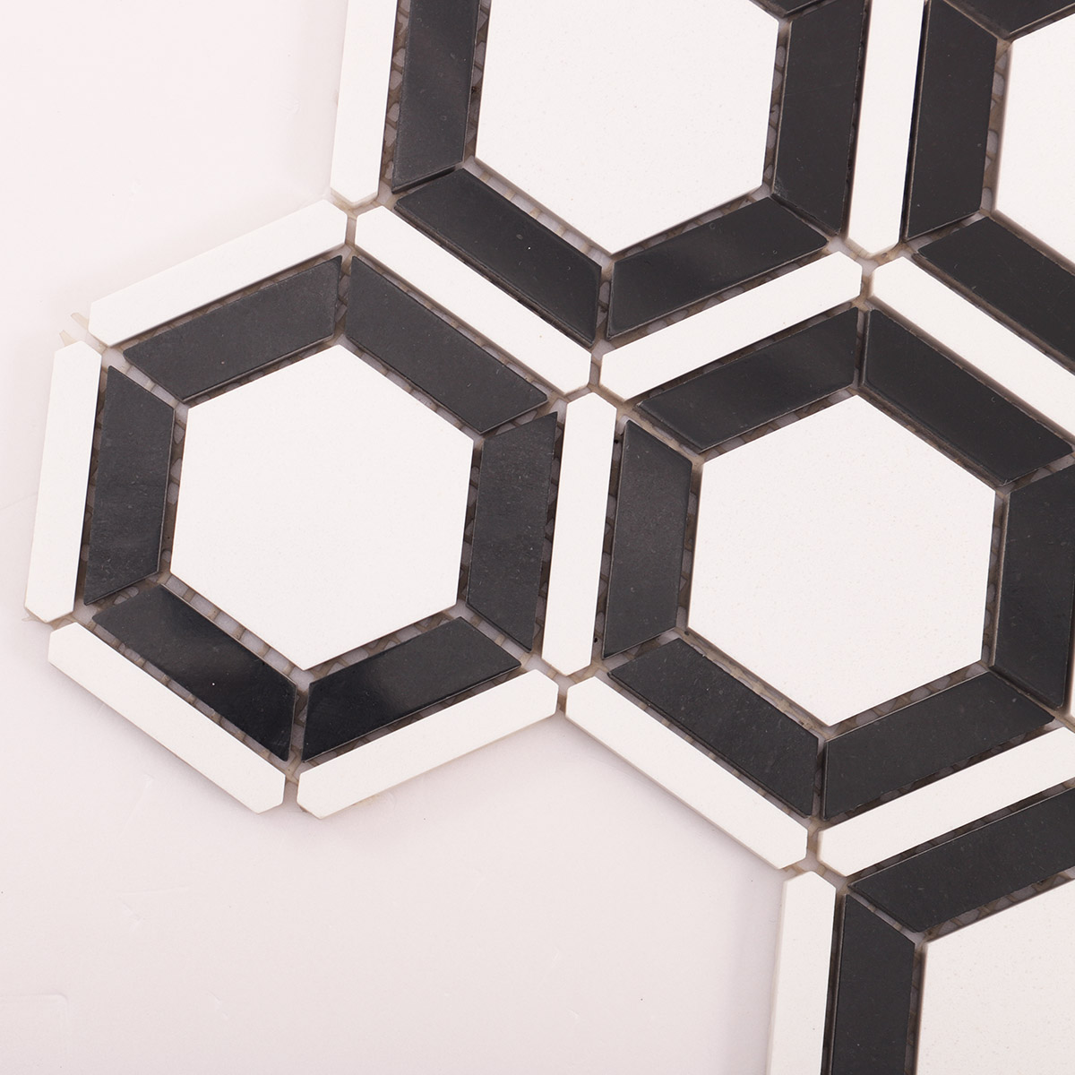 Detailed close-up of white and black hexagon marble mosaic tiles