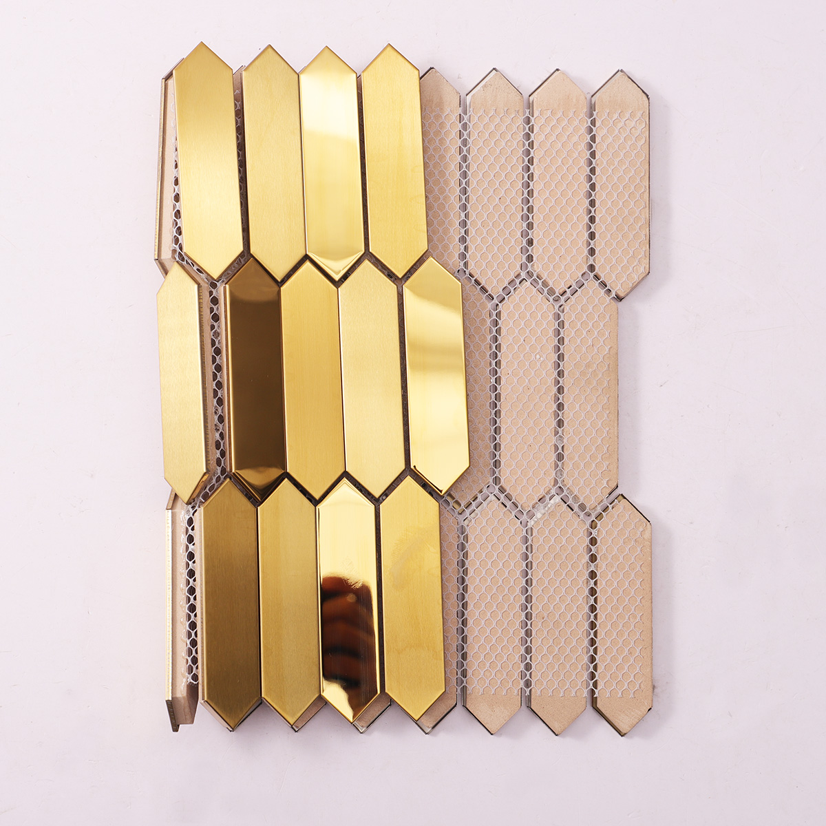 Folded back side of gold picket stainless steel mosaic metallic tiles.