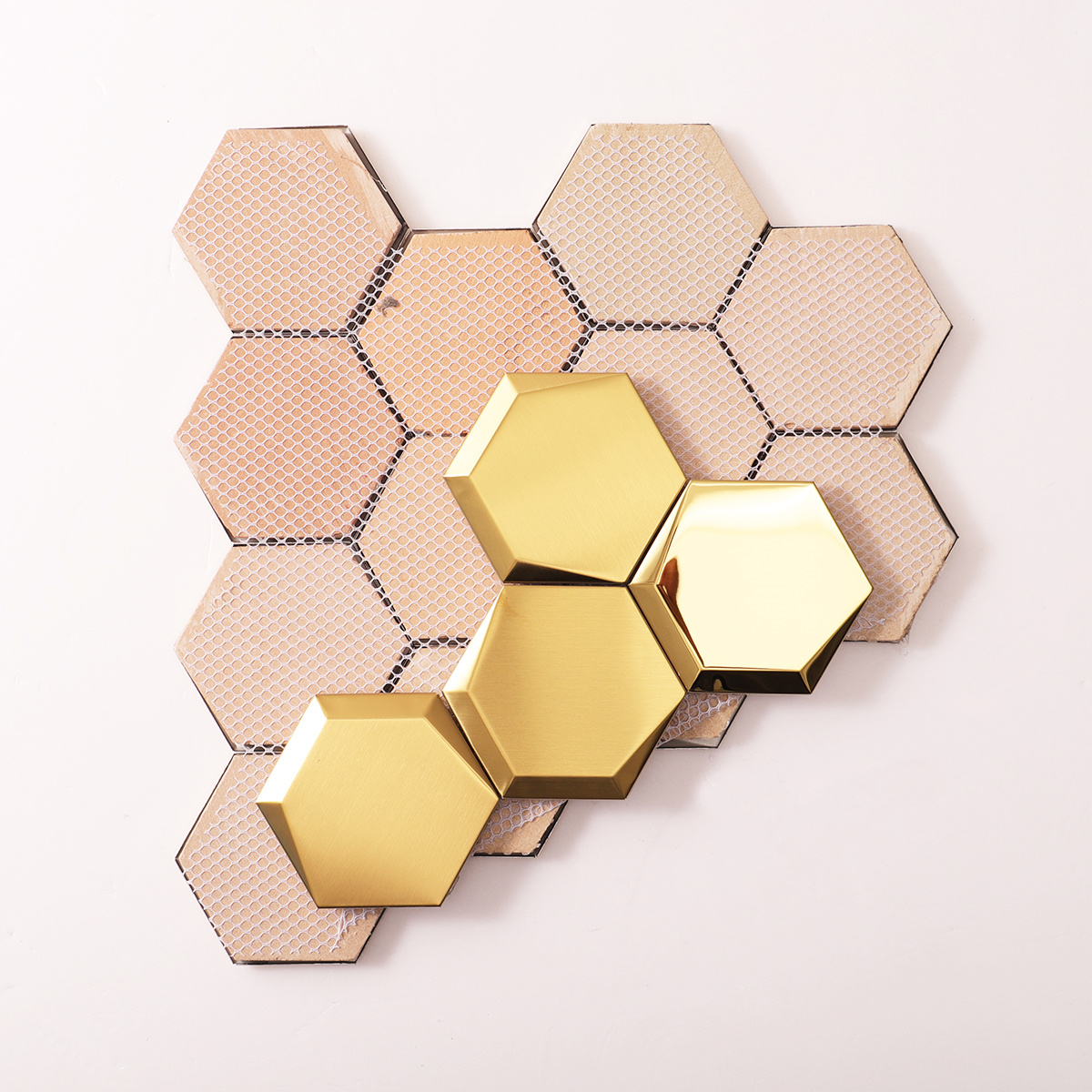 Folded back side of mirror hexagon gold stainless steel mosaic tiles.