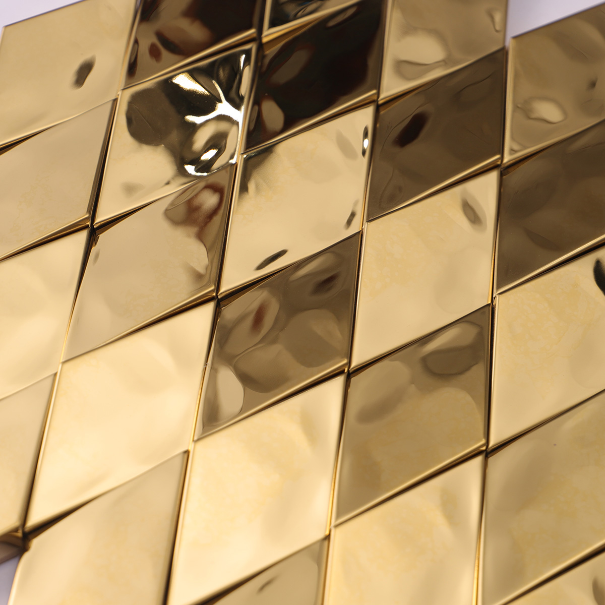 Close-up of gold diamond 3D stainless steel metal mosaic wall tiles.