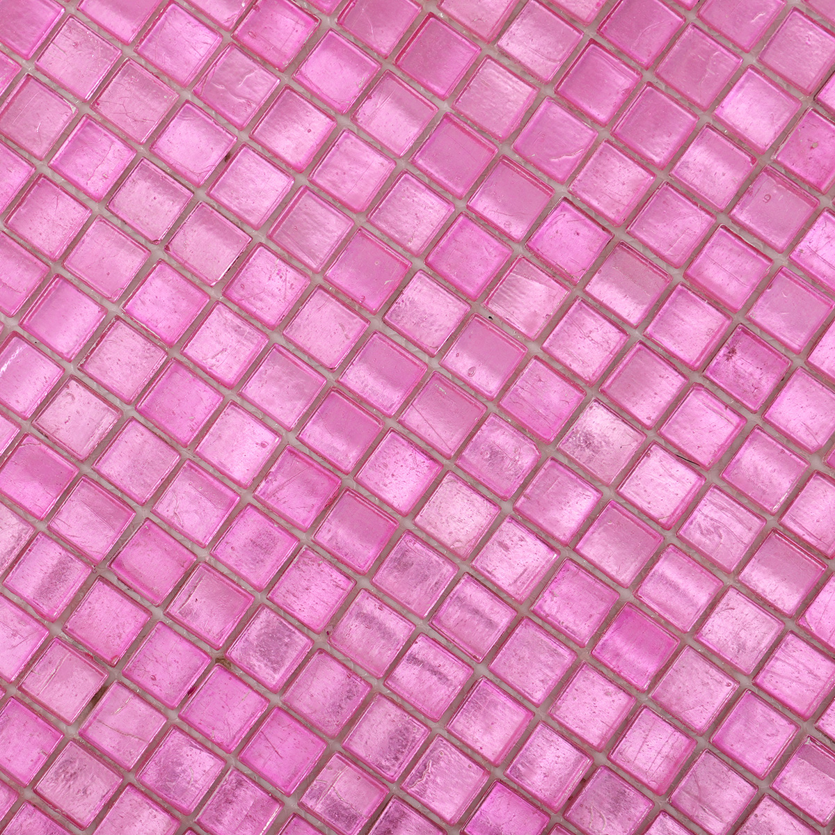 Close-up view of glossy uniform square pink foil glass mosaic tiles