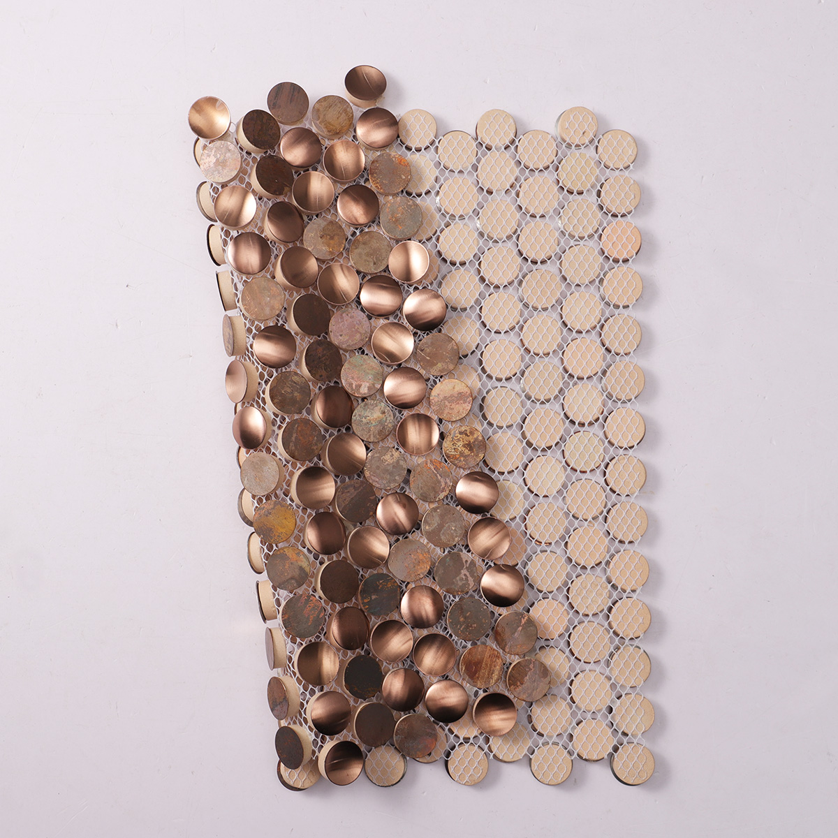 Folded back side of penny rounds stainless steel and copper mosaic tiles.
