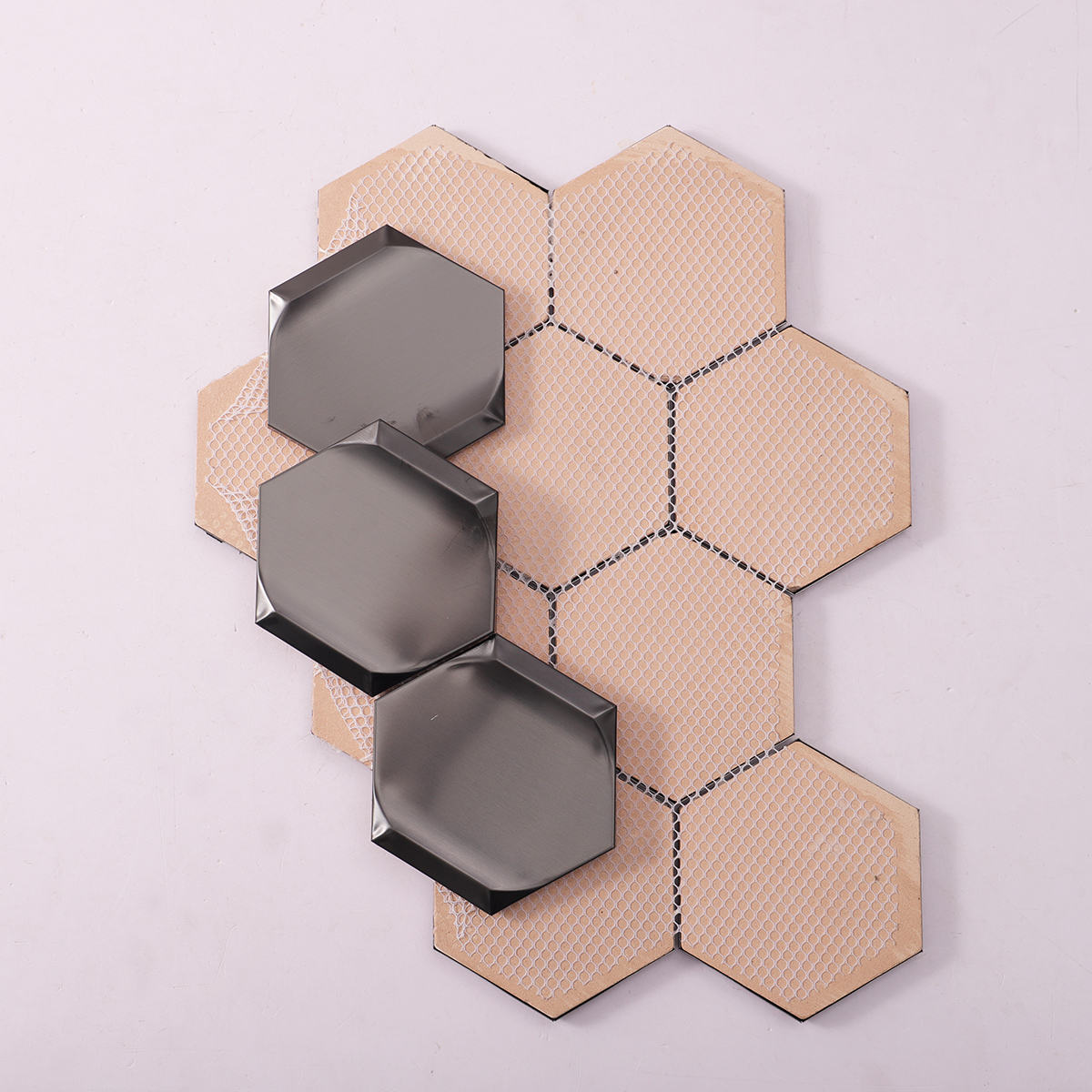 Folded back side of 3D black hexagon metal mosaic tiles.
