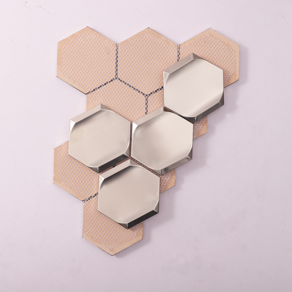 Folded back side of silver 3D stainless steel hexagon mosaic tiles.