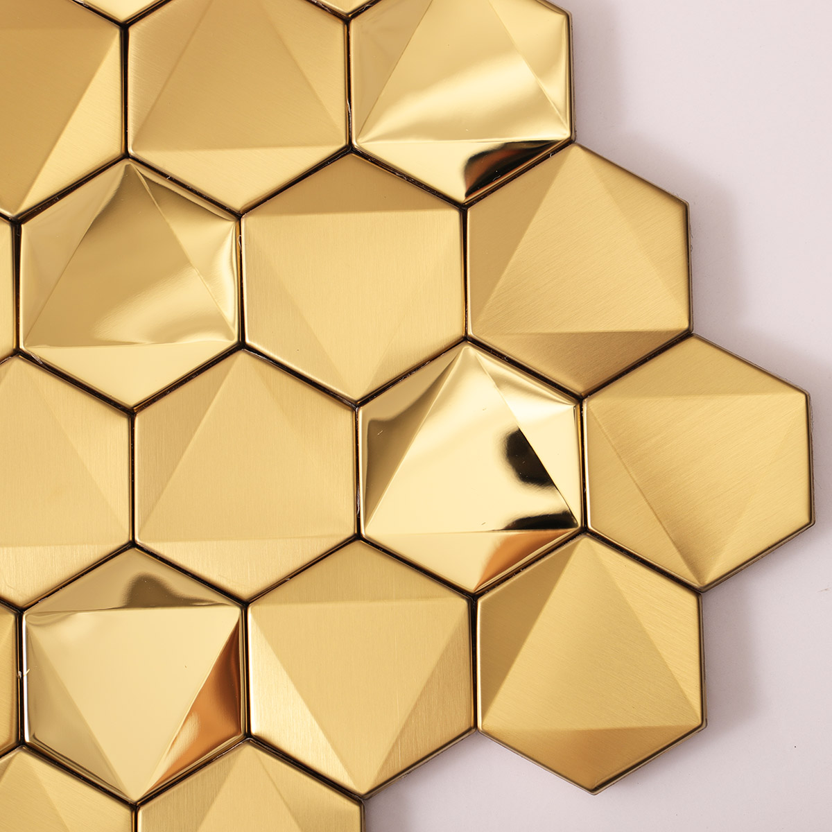 Macro close-up of hexagon gold 3D stainless steel mosaic tiles.