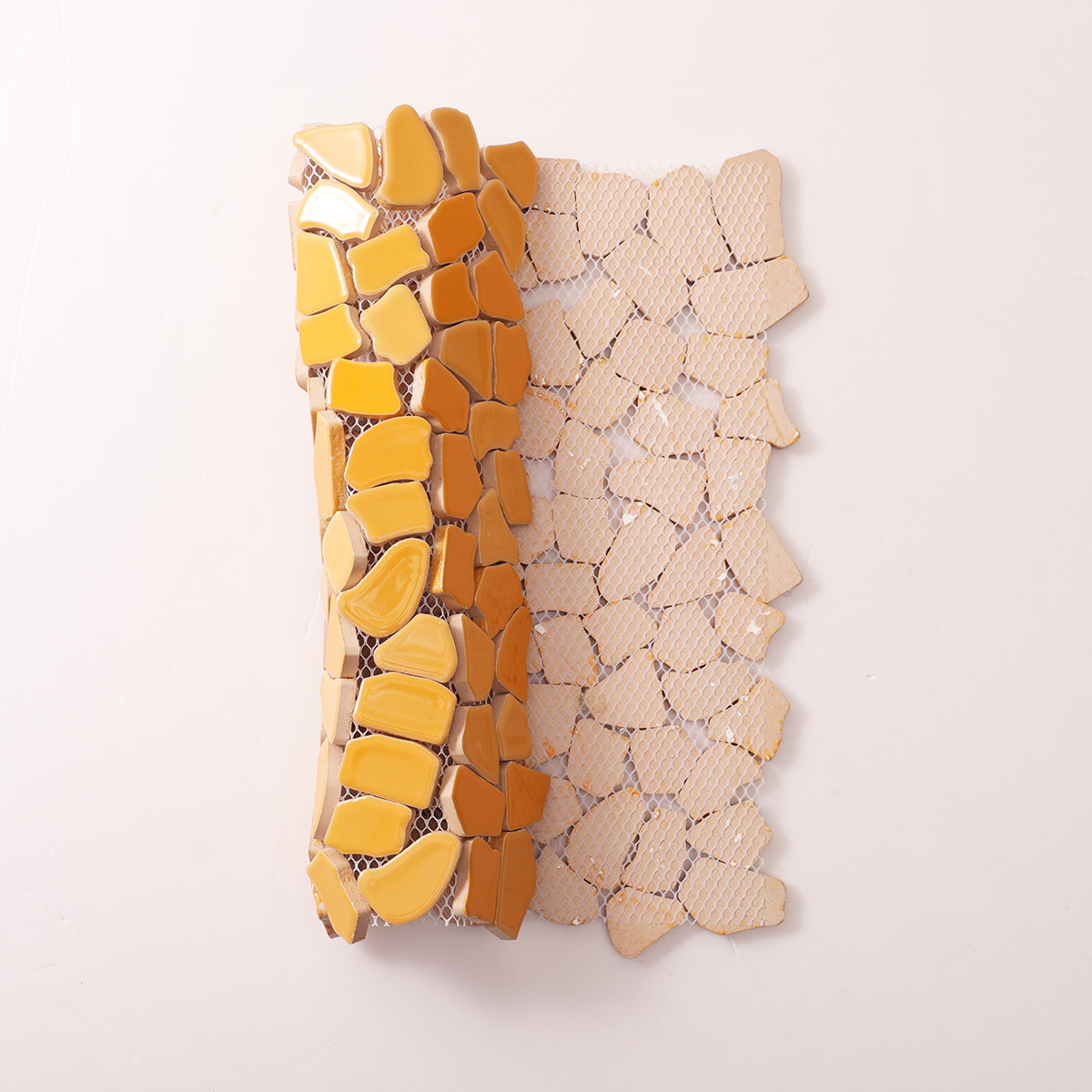 Folded back side of cracked ceramic mosaic art tiles.