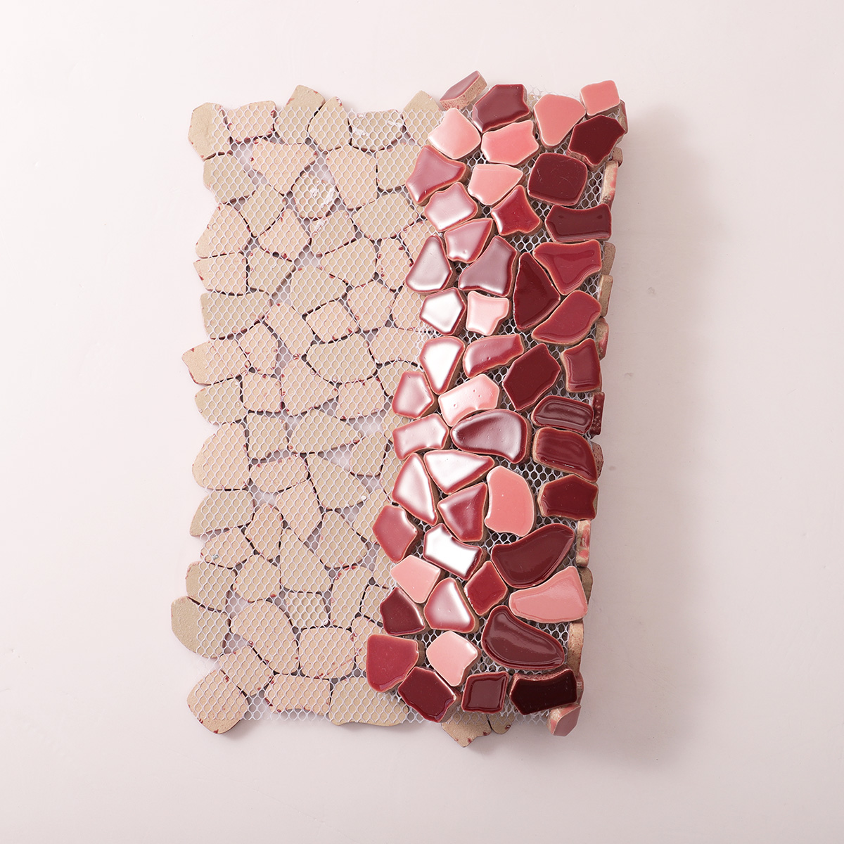 Folded back side of burgundy cracked ceramic mosaic tiles.