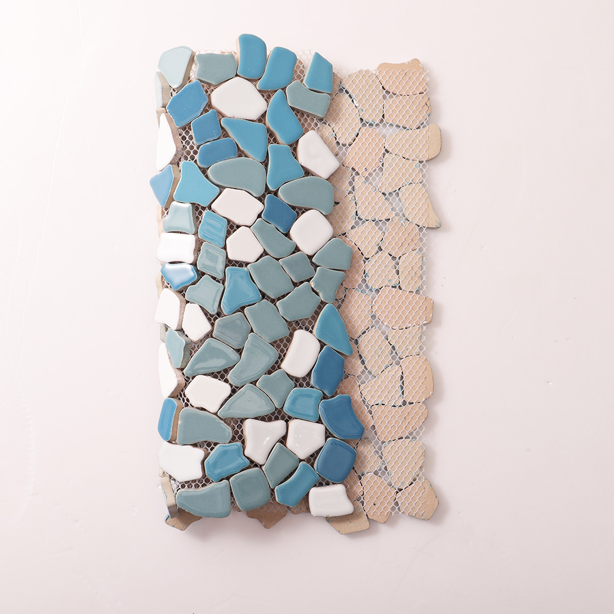 Folded back side of irregular broken ceramic pebble mosaic tiles