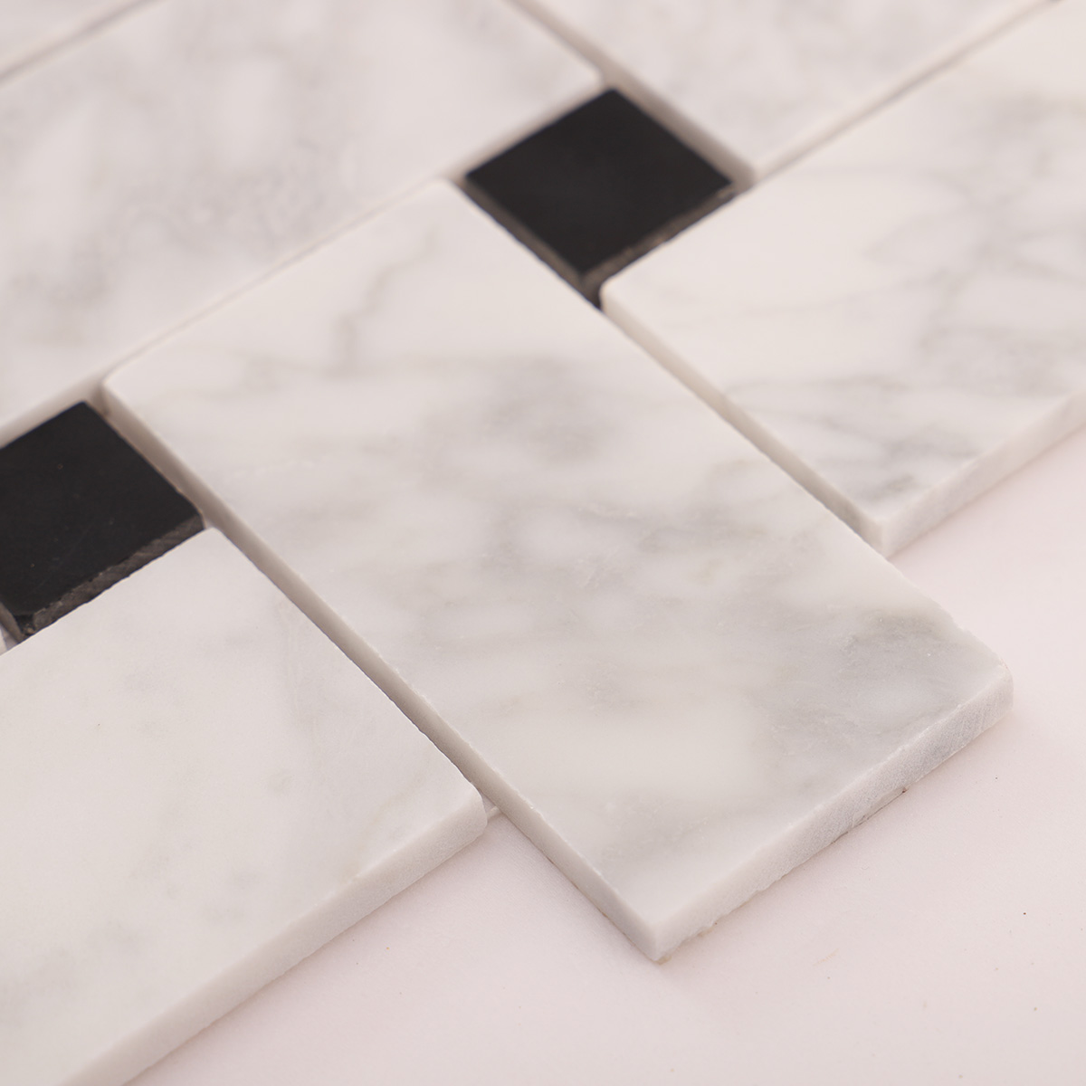 Detailed close-up of Carrara white basketweave marble mosaic tiles
