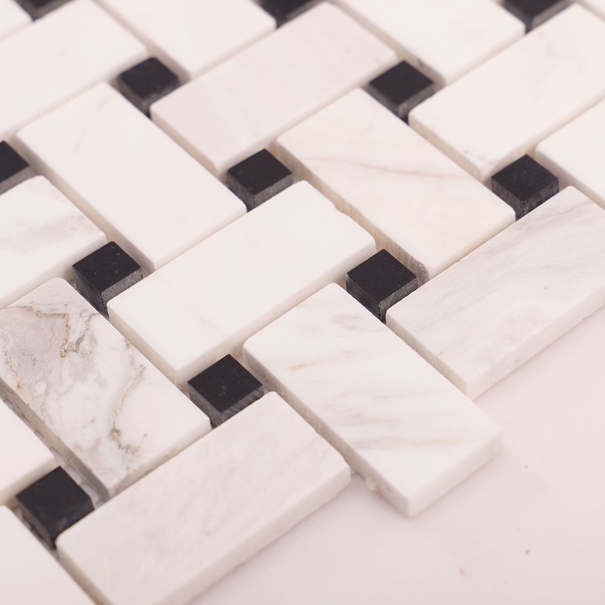 Close-up of white basketweave marble mosaic tiles.