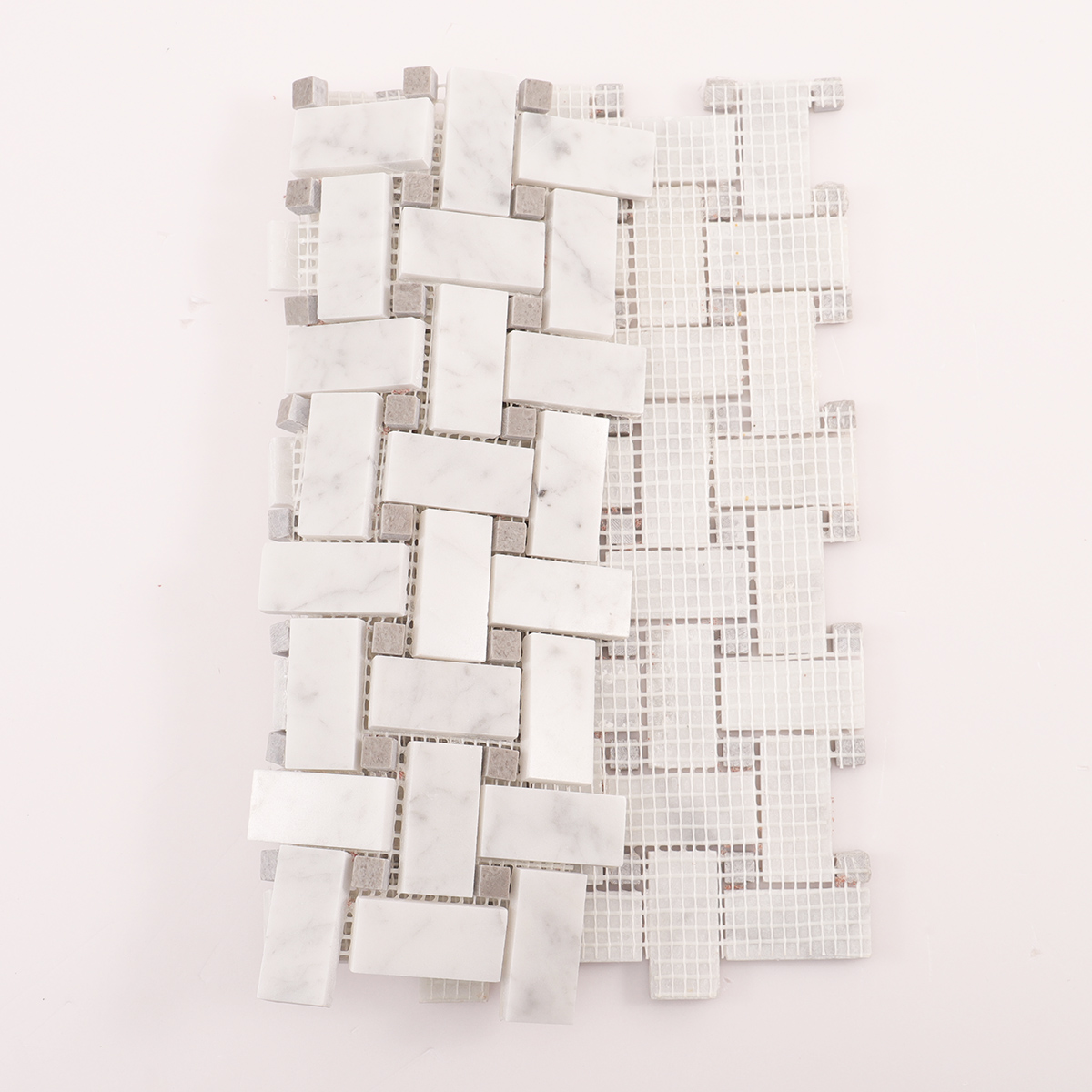 Folded back side of Carrara white basketweave marble mosaic tiles.