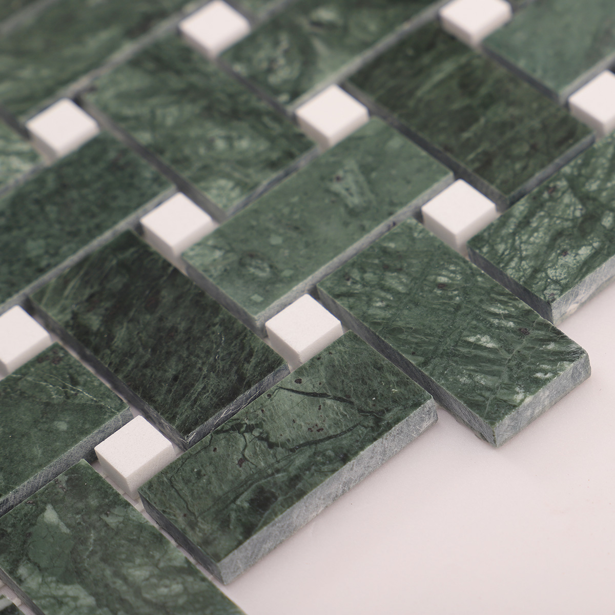 Side close-up view of Verde green basketweave marble mosaic tiles, showing texture and thickness.
