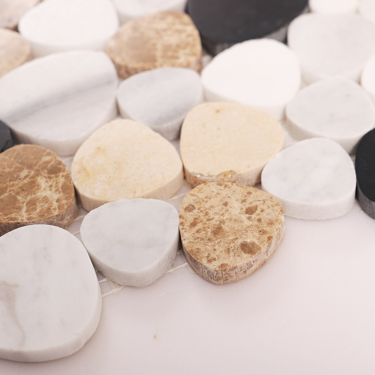 Side close-up view of mix pebble marble mosaic tiles, showing texture and thickness.