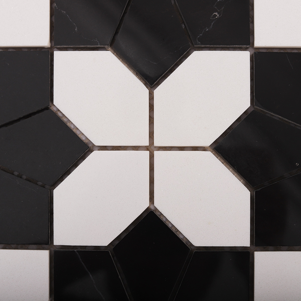 Detailed close-up of white and black floral marble mosaic tiles
