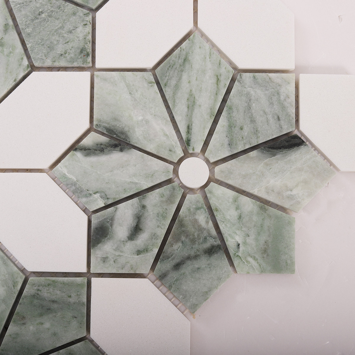 Detailed close-up of Ming green and white floral marble mosaic tiles.