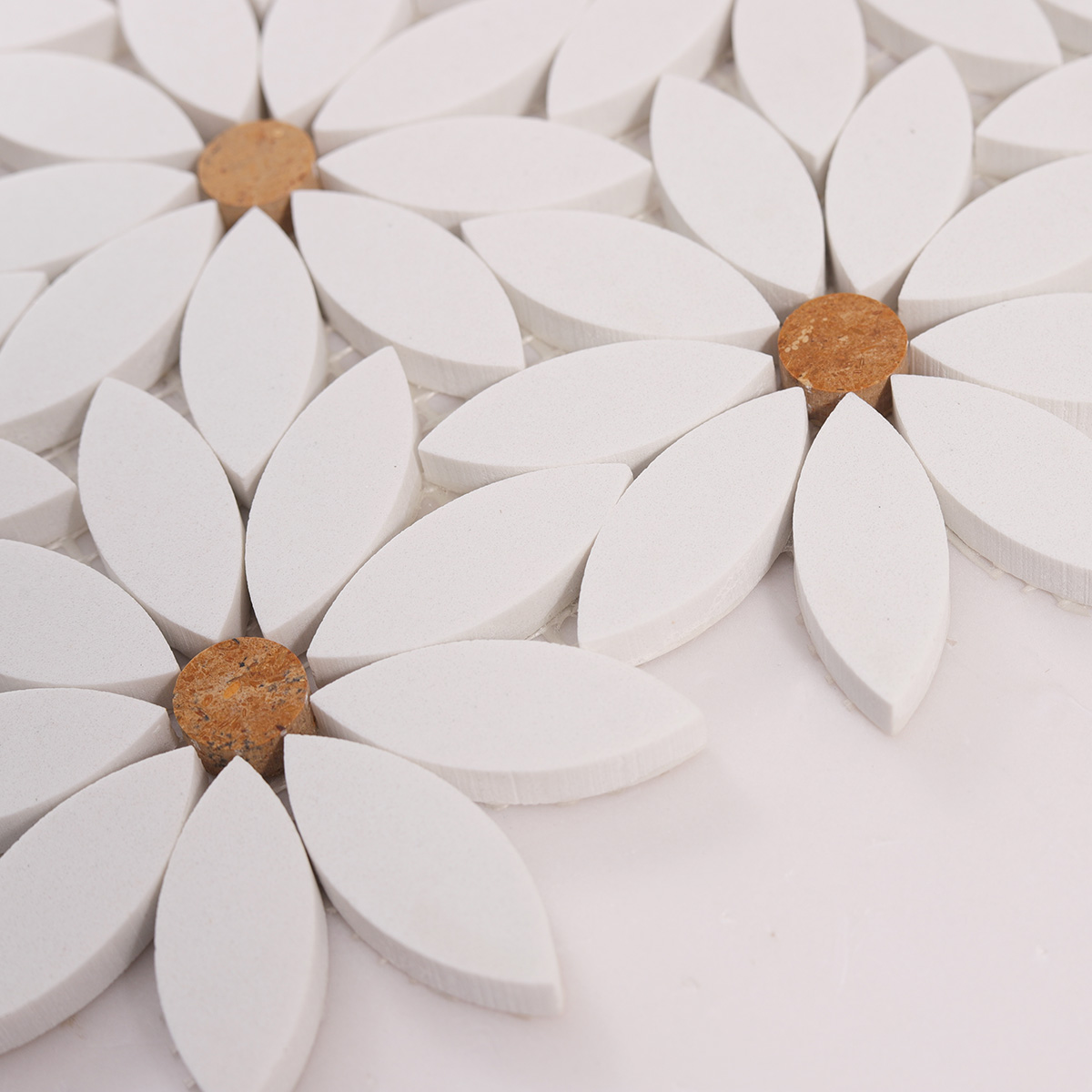 Side detail view of white waterjet sunflower marble mosaic tiles